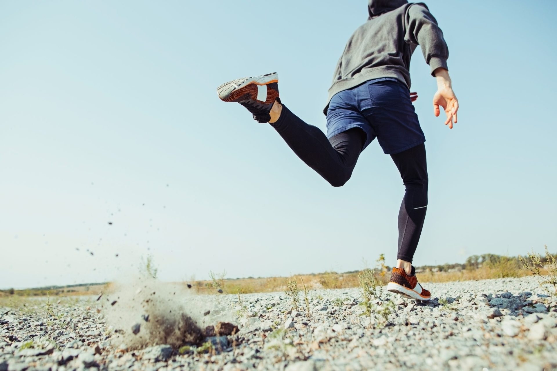 Running sport. Man runner sprinting outdoor in scenic nature. Fit muscular male athlete training trail running for marathon run.